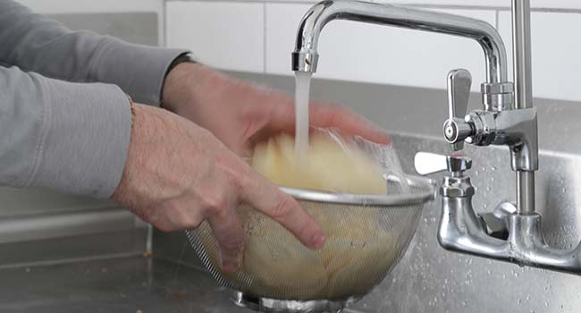 washing rinsed sliced potatoes