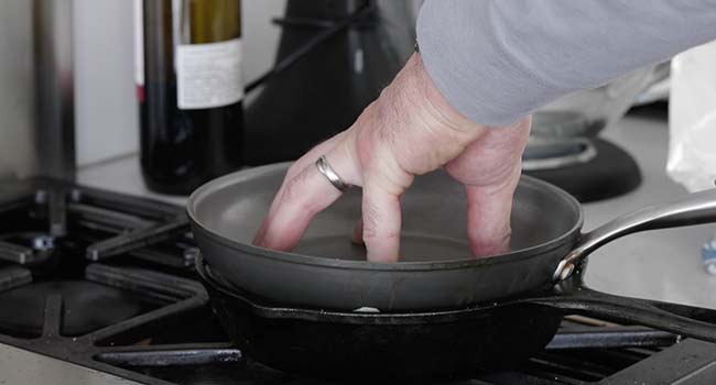 pressing down a pan in another