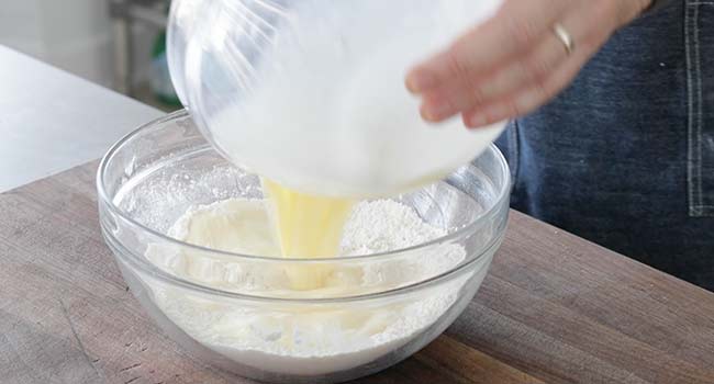 adding wet ingredients to dry ingredients