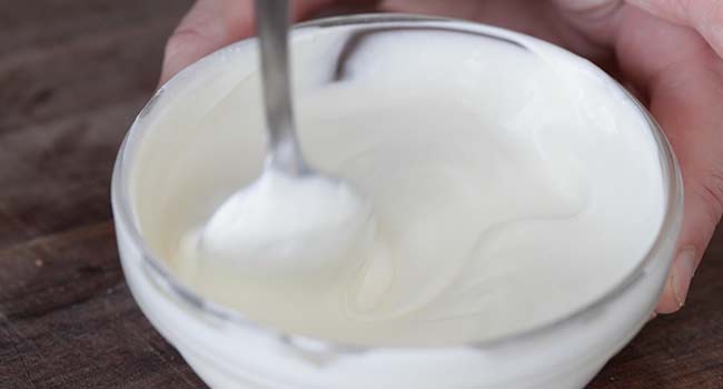 mixing together crema and mayonnaise