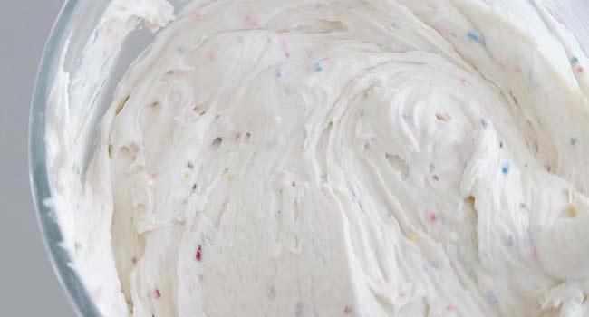 mixing sprinkles into a cake
