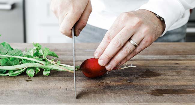 slicing the ends of a fresh radish