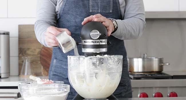 adding flour to a mixer