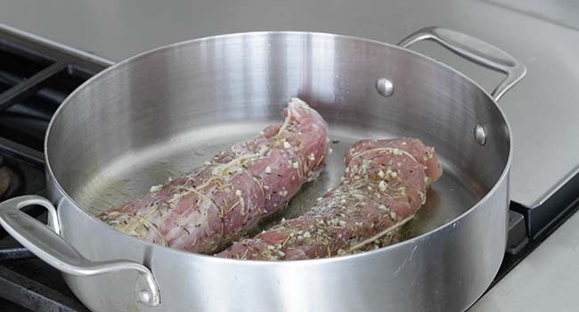 searing pork tenderloin in a pan