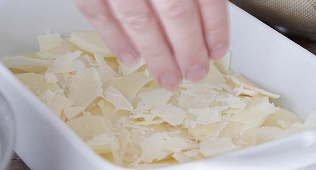 sprinkling cheese on potatoes