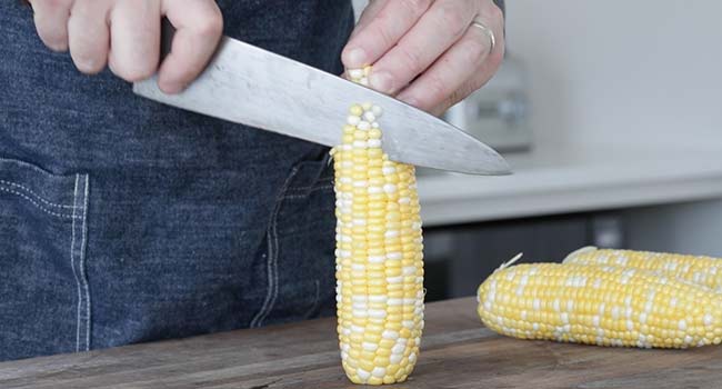 slicing corn off the cob