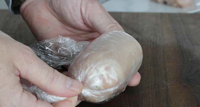 rolling chicken kiev in plastic wrap