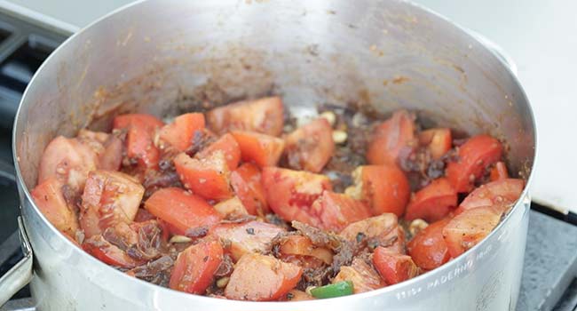 cooking tomatoes with onions and peppers