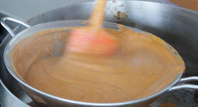 mixing together a sauce in a pan