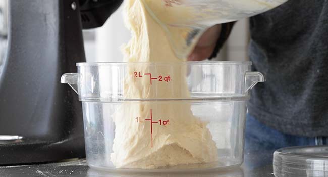 adding gooey butter dough to a container