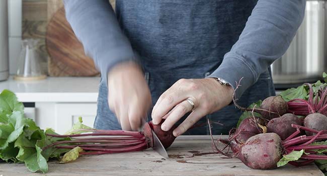 slicing the stems off of beets