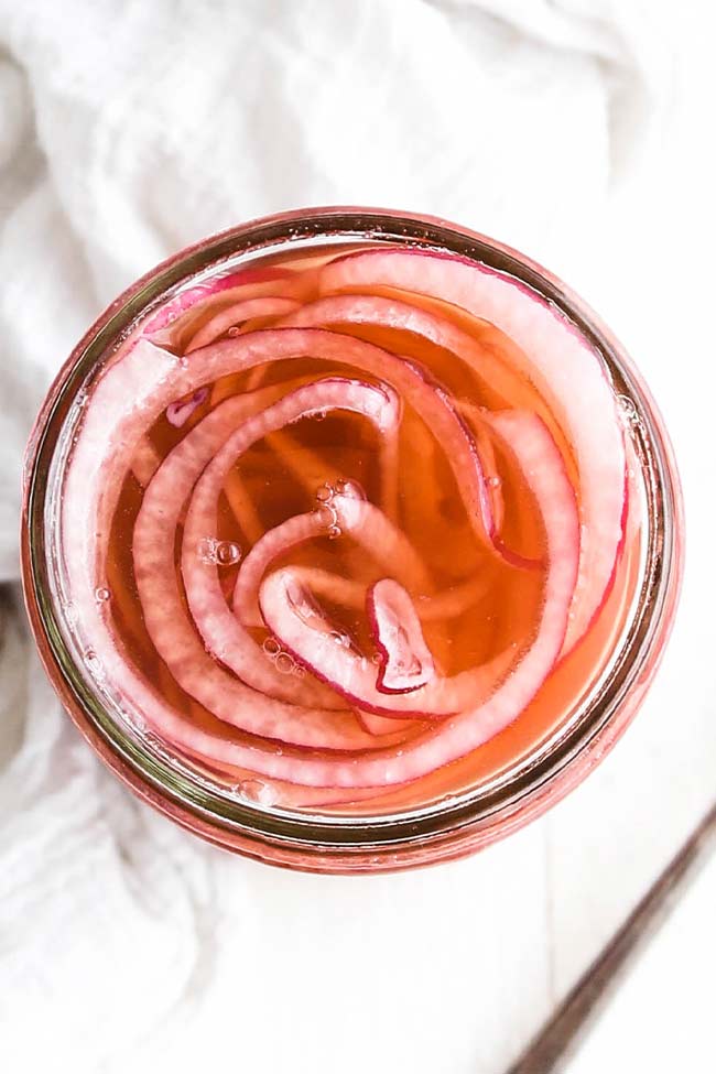 pickled red onions in a jar