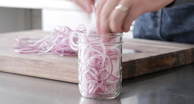 adding onions to a jar