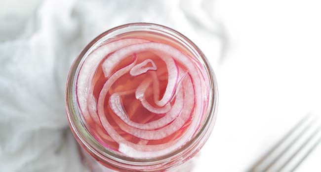 pickling red onions in a jar