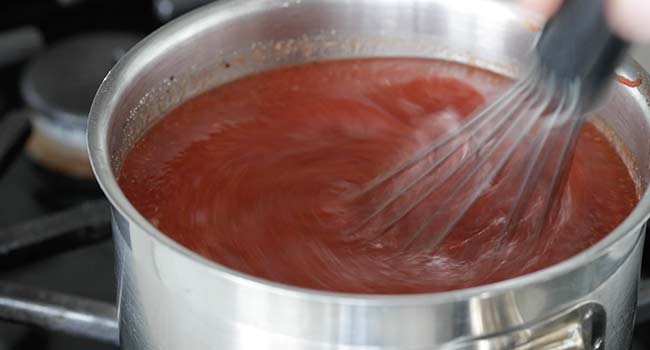 whisking together a bbq sauce