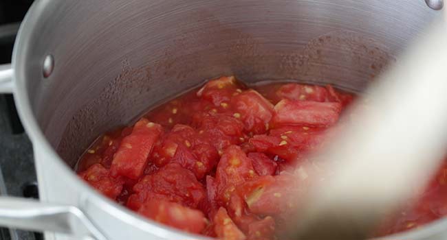 stewing garden tomatoes in a pot