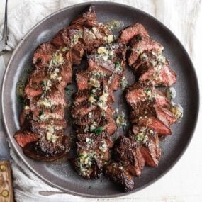 sliced coulotte steak on a plate