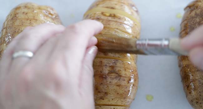 adding oil to a hasselback potato