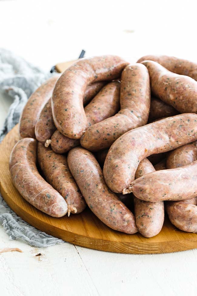 italian sausage links on a cutting board