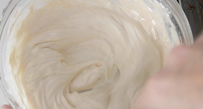 mixing together sour cream with flour