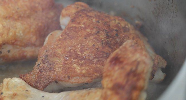 searing chicken in a pan
