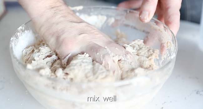 mixing pizza dough in a bowl