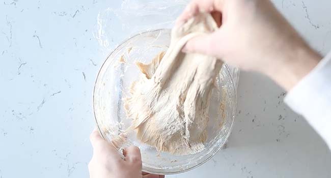 stretching and folding pizza dough