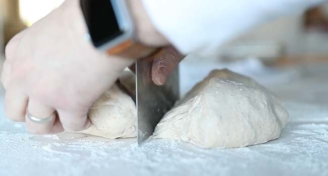 cutting pizza dough