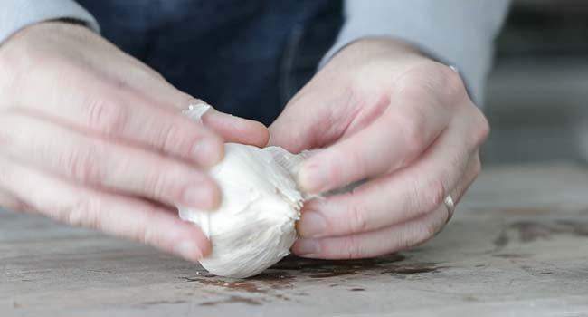 removing the skin from a garlic bulb