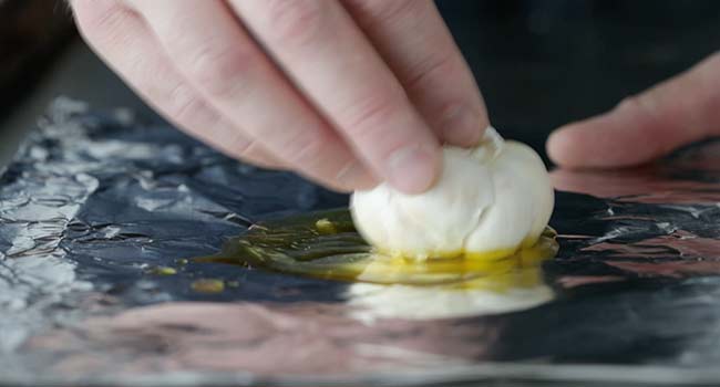 adding garlic to olive oil