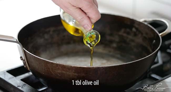 adding oil to a pan