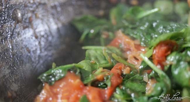 cooking spinach with tomatoes and onions