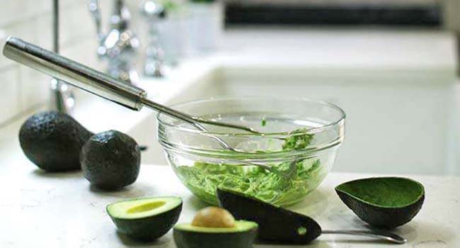 mashing avocados in a bowl