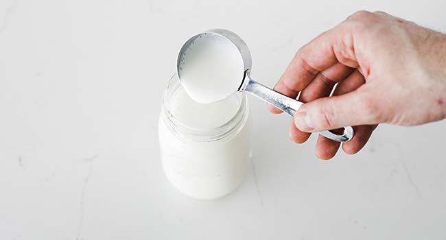 adding buttermilk to a jar