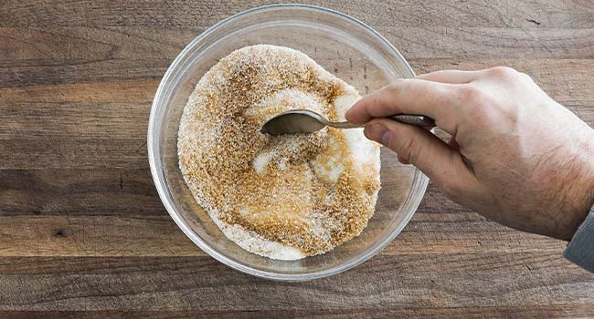 mixing together cinnamon and sugar