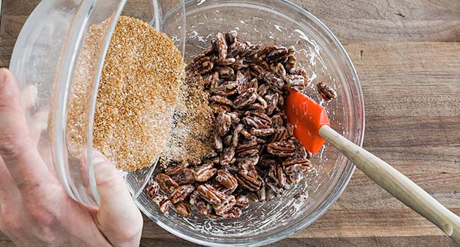 mixing together pecans with cinnamon and sugar