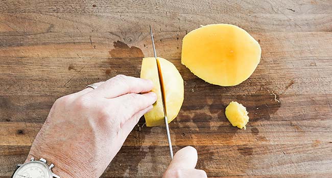 cutting the side of a mango