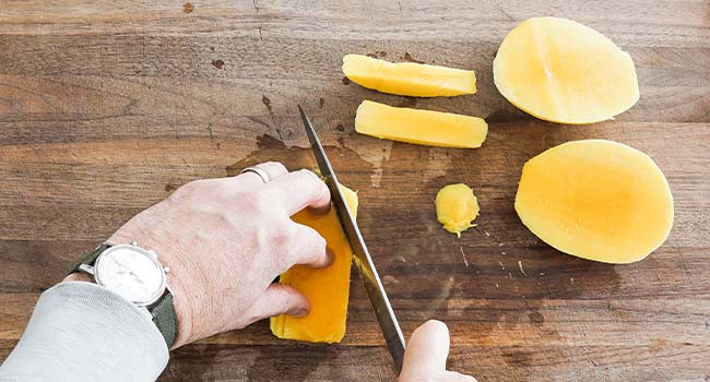 cutting off the ends of a mango