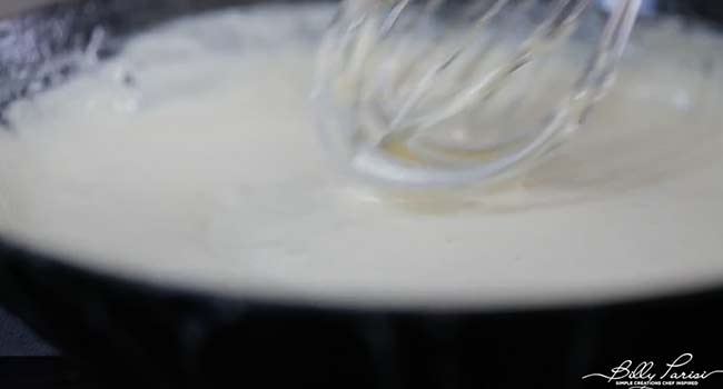 whisking cream in a pan