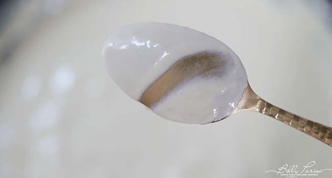 cream sauce coating a spoon