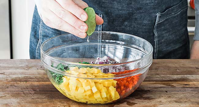 squeezing a lime into a bowl