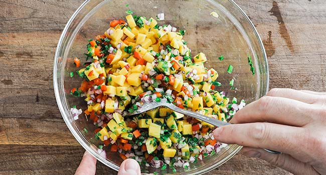 mixing a mango salsa