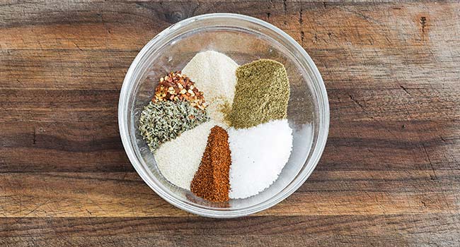 adding spices to a bowl