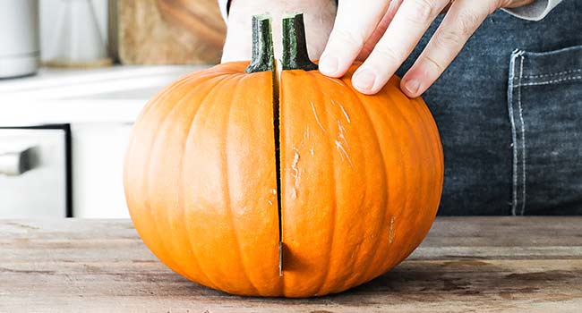 cutting a pumpkin in half