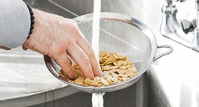 rinsing the pumpkin seeds