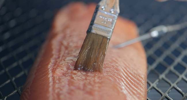 brushing a salmon with a glaze