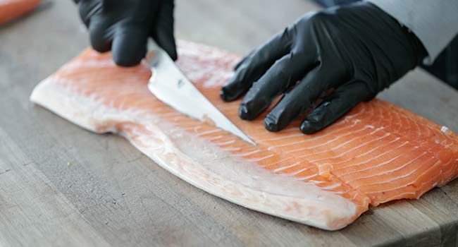 removing the belly from a salmon