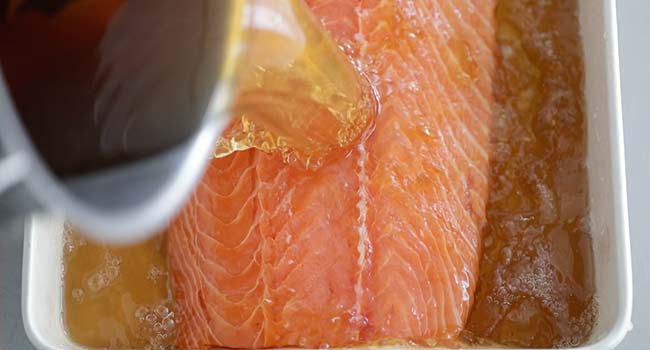 pouring a brine onto salmon