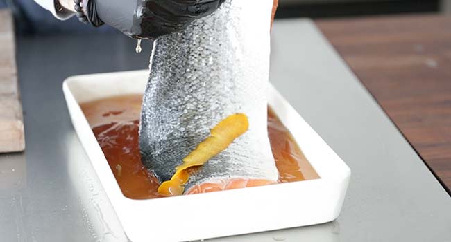 flipping a salmon over in brine