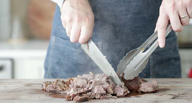 cutting up braised lamb